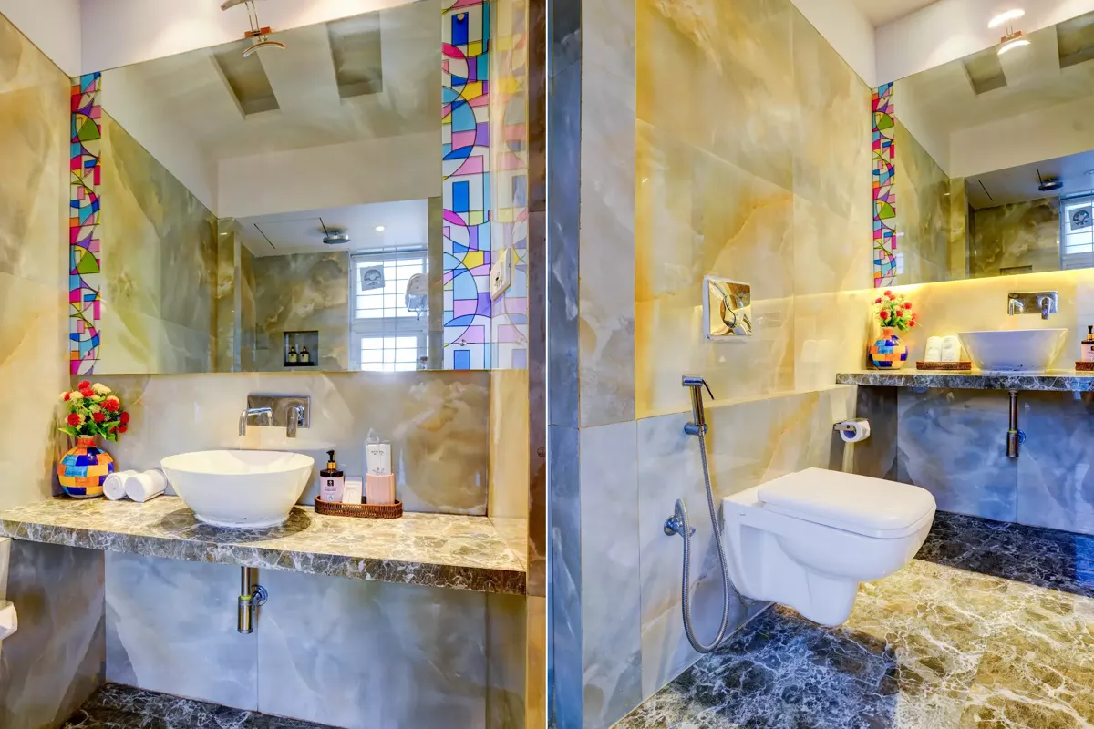 Onyx marble bathroom with stained-glass detail at LonavillaStay villa